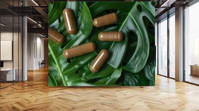 Organic herb capsules on green leaves Wall mural