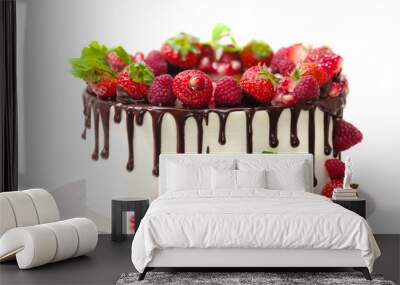 cake covered with berries of raspberry strawberry pomegranate mint leaves doused with chocolate on an isolated white background Wall mural