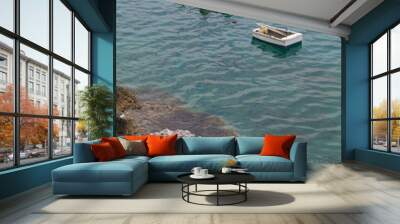 Two boats on crystal clear turquoise sea water and gray rocky coast  in Greece. Wall mural