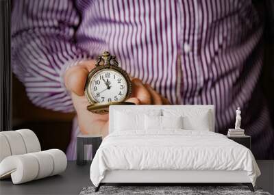 a pocket watch in the hands of a man Wall mural