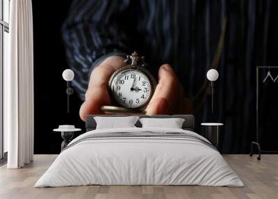 a pocket watch in the hands of a man Wall mural