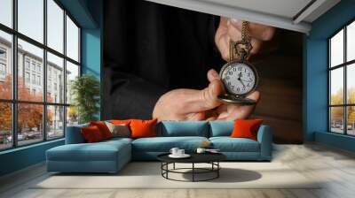 a pocket watch in the hands of a man Wall mural