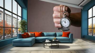 a pocket watch in the hands of a man Wall mural