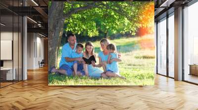 family reading bible in nature  Wall mural