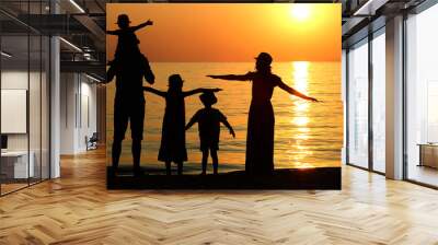 family silhouette at sunset by the sea... Wall mural