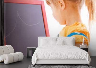 Happy baby girl beautiful painting on the easel on a white background Wall mural