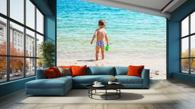 Happy child playing on the sea background Wall mural