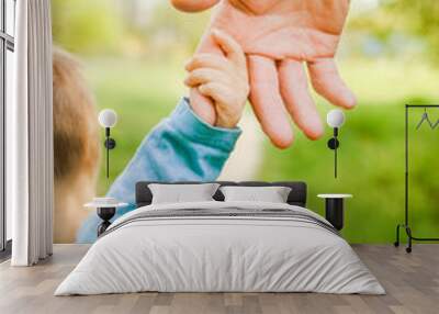 the parent holding the child's hand with a happy background Wall mural