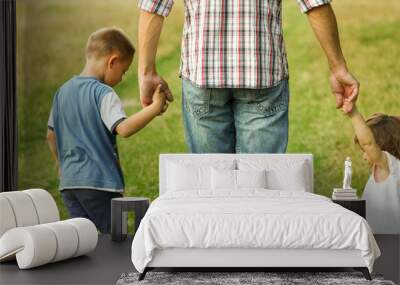 the parent holds the hand of a l child Wall mural