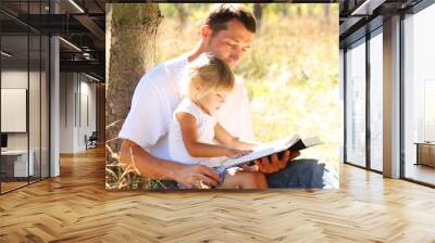 young father with his little daughter reads the Bible Wall mural