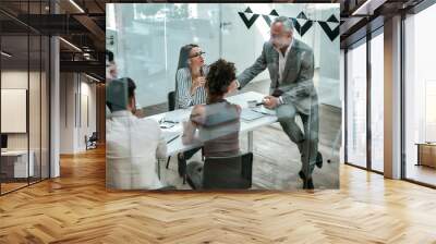 Business people. Confident mature man in formal wear explaining something to his colleagues while sitting on the office table behind the glass wall in the modern office Wall mural