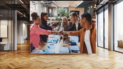 Group of coworkers stacking hands together one by one in unity. Support and motivation concept Wall mural