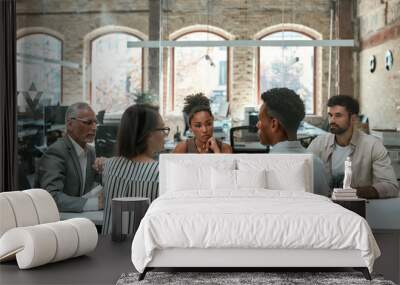 Important meeting. Group of business people discussing something and working together while sitting at the office table Wall mural