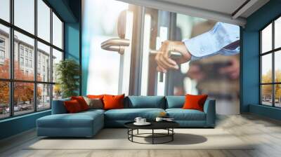 Male hand opening glass door in the modern office, close up shot Wall mural