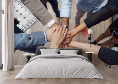 Top view of group multi ethnic coworkers stacked hands together as concept of corporate unity Wall mural