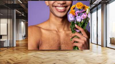 Transgender latin american man smiling with flowers in hand close up portrait. Handsome sensual model Wall mural