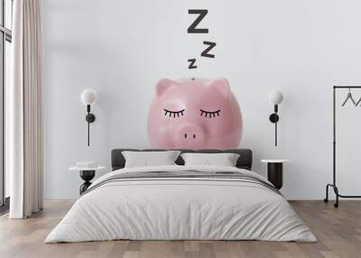 Pink piggy bank pictured sleeping on gray background Wall mural