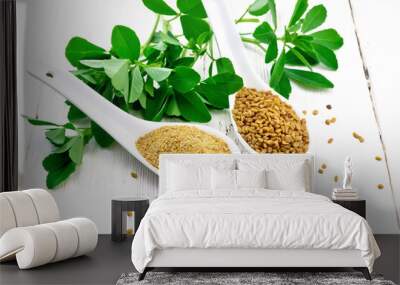 Fenugreek in two spoons with leaves on board Wall mural