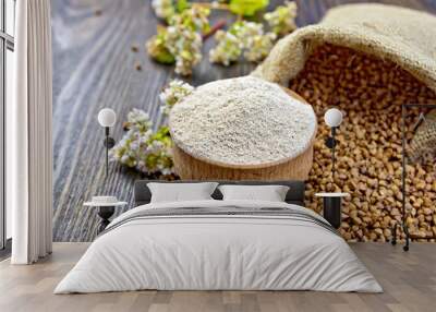 Flour buckwheat in bowl with cereals and flower on board Wall mural