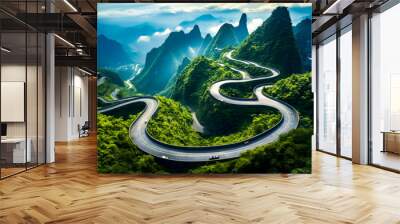 Aerial view of winding road in the mountains with mountain range in the background. Wall mural