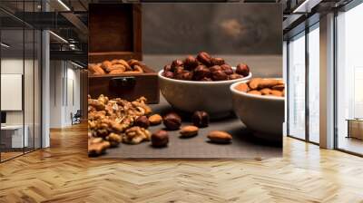 Two white cups with nuts, almonds, hazelnuts, walnut and a wooden box with almonds, side view Wall mural