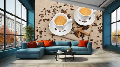 two cups of coffee and coffee beans on the background Wall mural