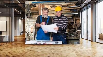 Two men studying the project Wall mural