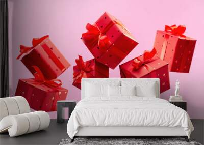 Many traditional gift boxes are falling on pink background. Festive season is bustle. Selection of gifts. Festive events. Wall mural