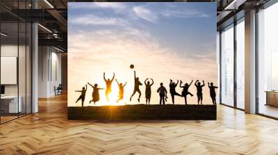 Silhouette of happy business group team over sunset sky. Success and teamwork concept in company with hands up over beautiful sunset sky for business success and teamwork concept in company Wall mural