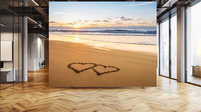 Valentines day on sunny beach. Two hearts drawn in sand, love concept Wall mural