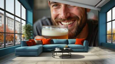 Closeup man holding a beer with blurred background.Beer drinking and Octoberfest concept Wall mural