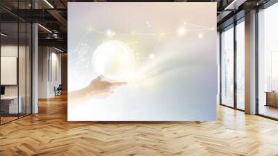 Bright light ball over human hand. Wall mural