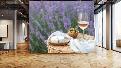 Glass of white wine in a lavender field. Violet flowers on the background. Wall mural