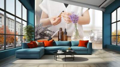 Using natural essential oil in a home spa ritual. A woman takes care of her skin and hair. Wall mural