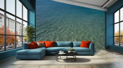 Blue turquoise ocean water on a sunny and beautfiul summer day, with a sandy ocean floor Wall mural