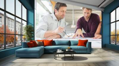 Business people reading paperwork in office meeting Wall mural