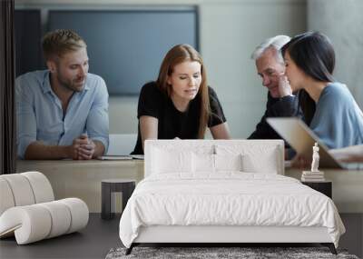 Business people reviewing paperwork in meeting Wall mural