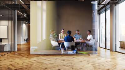 Casual business people working at tables in open office Wall mural