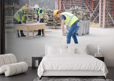 Construction worker sweeping at construction site Wall mural