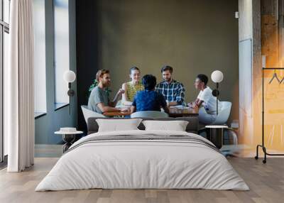 Creative business people working at tables in sunny office Wall mural