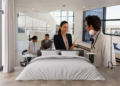 Doctor and businesswoman handshaking in meeting Wall mural