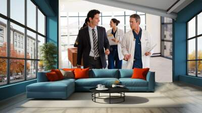 Doctors talking in hospital corridor Wall mural