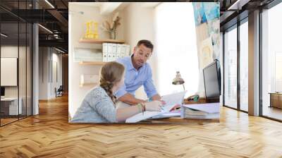 Father helping teenage daughter with her homework Wall mural