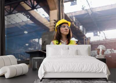 Female steel worker with walkie-talkie in factory Wall mural