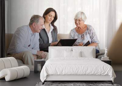 Financial advisor using tablet computer with clients Wall mural