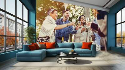 Friends toasting champagne glasses at patio table Wall mural