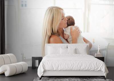 Mother holding baby girl in nursery Wall mural