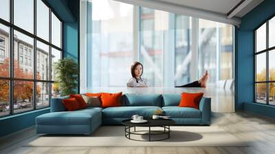 Portrait confident businesswoman bare feet up on conference room table Wall mural