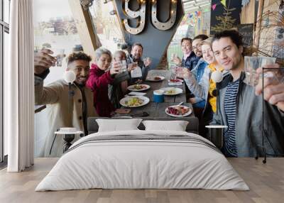 Portrait of smiling friends eating at restaurant outdoor patio Wall mural