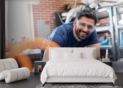 Portrait smiling mechanic working in auto repair shop Wall mural